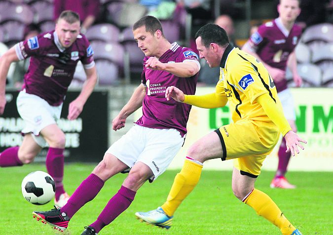 Galway FC's Jake Keegan gets in his shot despite the attentions of Longford Town's Pat Flynn during Friday night's First Division tie at Eamonn Deacy Park. Photos: Joe O'Shaughnessy.