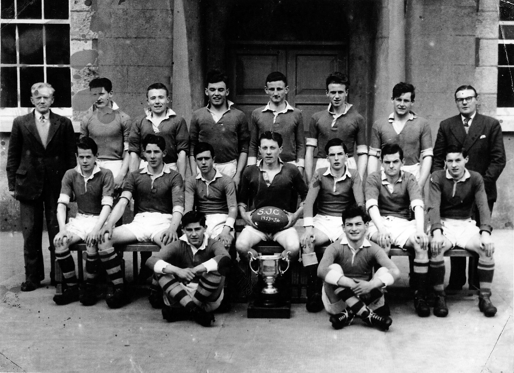 The St Joseph’s College, ‘The Bish’, team from Galway who won the Connacht Senior Schools Rugby Cup sixty years ago, in 1954, defeating St Joseph’s College, Garbally, Ballinasloe, in the replay of the final at Galway Sportsground. Back row: Mr Harry Warner, Commerce Teacher, Greg Scally, Willie O’Flynn, Jimmy Clancy, Frank Walsh, Dom Moloney, Des Nolan, Mr Jack Deacy, Coach. Seated: Sean Burke, Ger Lernihan, Noel Carpenter, Gay Lee (captain), Tom Killeen, S (Hockey) Nestor, Micky Joyce. Front row: Eamonn O Máille and Johnny Beatty. The Bish won by 6 points to 3 (two tries to a penalty, Ger Lernihan and Willie O’Flynn scoring for the Galway side and G Reynolds had the Ballinasloe side’s lone score).