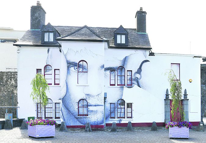 Art attack: Artist Joe Caslin's portrait of Peter Bradshaw, son of Galway Harbour CEO Eamon Bradshaw, on the front of Comerford House beside the Spanish Arch.