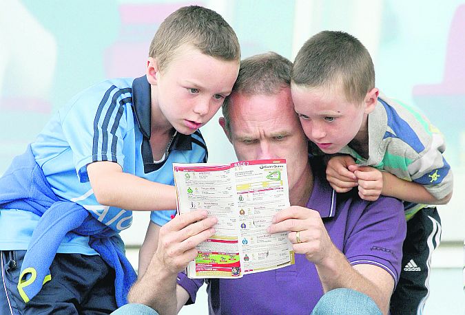 That one, Daddy.....picking winners is a family affair at the Galway Races. Photo: Iain McDonald.