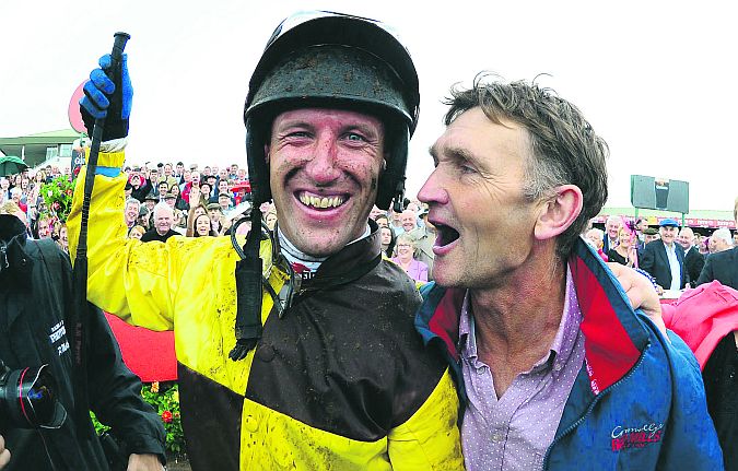 Trainer Michael Winters and jockey Robert Power celebrate after winning the Guinness Galway Hurdle with Missunited last year.