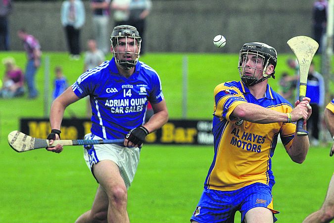 Portumna's Owen Treacy clearing his lines as Ardrahan's John Greene closes in during Sunday's championship encounter in Loughrea. Photo: Enda Noone.