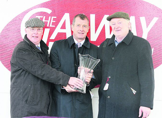 Kilconly's Gabriel Walsh and Tuam's Jim Murphy, owners of Aerlite Supreme, recieve the winners' trophy from Frank Fahy, Galway Race Committee, centre, after landing the CCTV Venue Control Maiden Hurdle at last year's October Bank Holiday meeting.