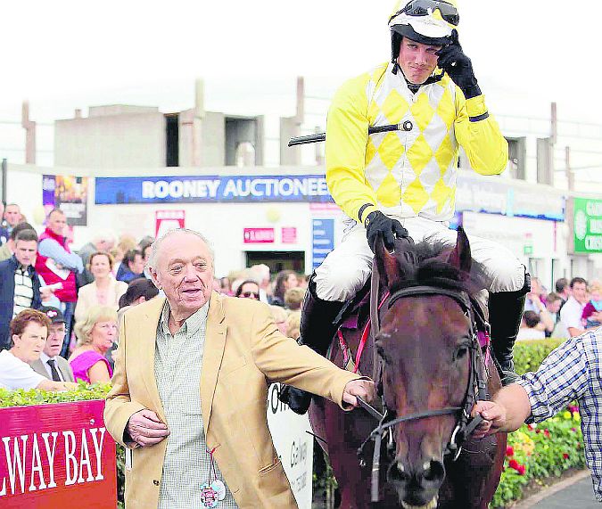 Herb Stanley from Loughrea leads Beckwith Star and jockey Brian Hayes back to the winners' enclosure after landing the Easyfix Rubber Products Handicap Hurdle at Ballybrit on Monday evening. Photos: Iain McDonald.