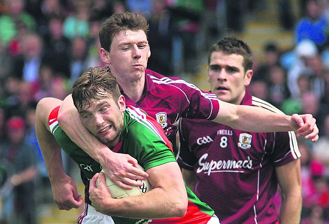 Galway midfielder Thomas Flynn tries to halt the progress of Mayo's Aidan O'Shea during Sunday's Connacht final in Castlebar. Photo: enda noone.