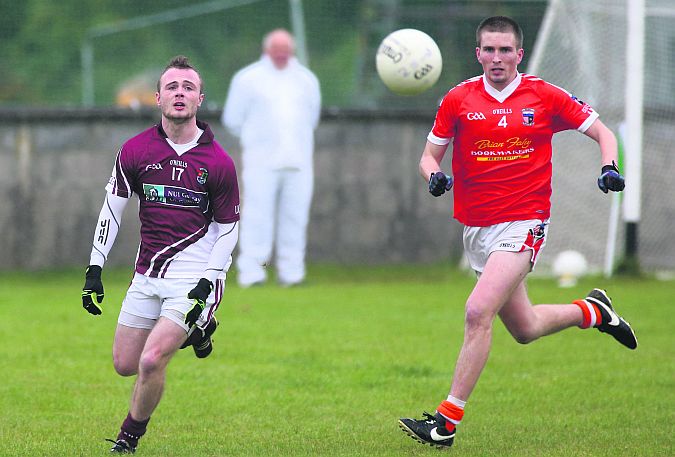 NUIG's Niall Lee and Barna's Michael Collins follow the flight of the ball during Sunday's senior football championship tie in Moycullen. Photo: Joe O'Shaughnessy.