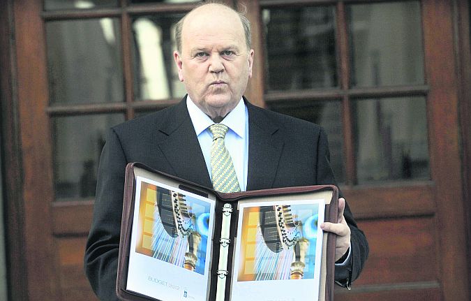 Another one on the way...Minister for Finance Michael Noonan poses with his Budget on the steps of Government Buildings.