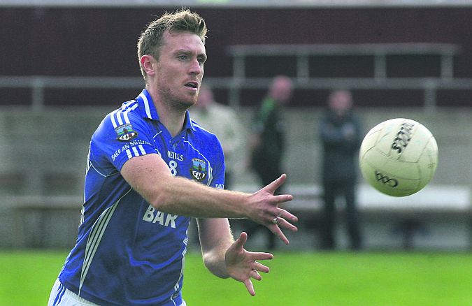 Milltown's Cathal Blake gets the ball away against Salthill/Knocknacarra during Saturday's senior football championship quarter-final at Tuam Stadium. Photos: Enda Noone.