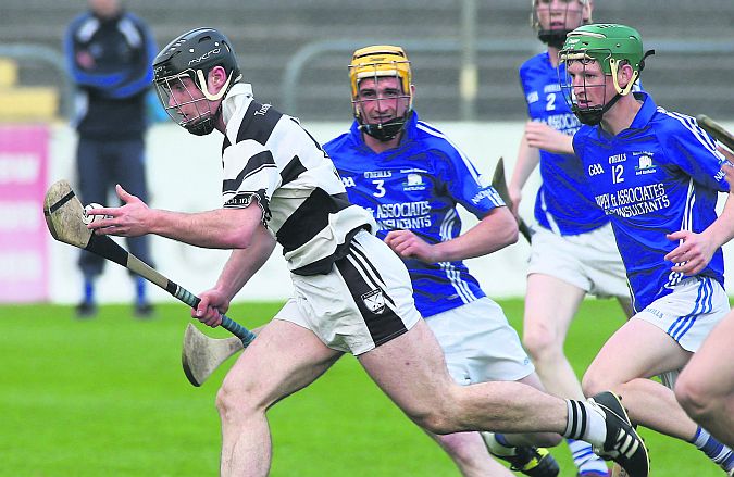 Turloughmore's Sean Linnane is chased by Ardrahan's Colm Whelan and Pearce McCrann during Saturday's minor A hurling semi-final at Kenny Park. Photos: Joe O'Shaughnessy.