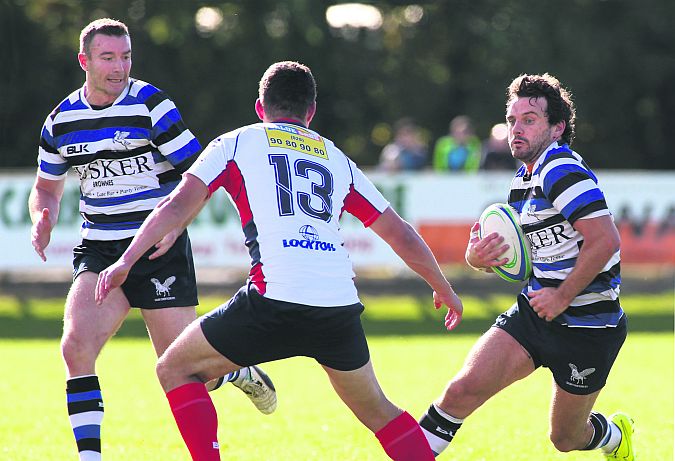 Corinthians Darin Claasen and Mickey Murphy lead this offensive against Malone's Mickey Murphy in Saturday's AIL tie at Cloonacauneen. Photo: Joe O'Shaughnessy.