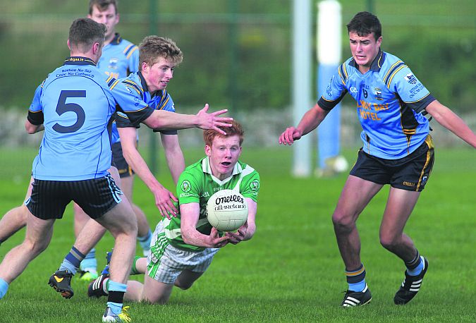 Salthill Knocknacarra's Cian Shaughnessy, Marcus Mac Donnachada and John Maher surround Moycullen's Peter Cooke in the West Board Minor A football final in Inverin on Sunday. Photo: Joe O'Shaughnessy.