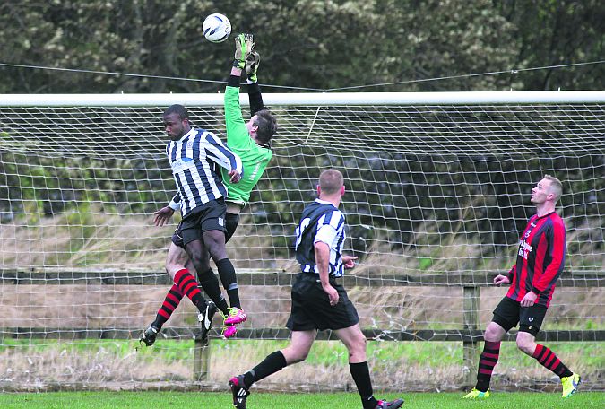 Davis Mbata of Galway Hibs and Corofin United goalkeeper Conan Clarke in an aerial duel in their game in Bohermore on Sunday. Photo: Joe O'Shaughnessy.