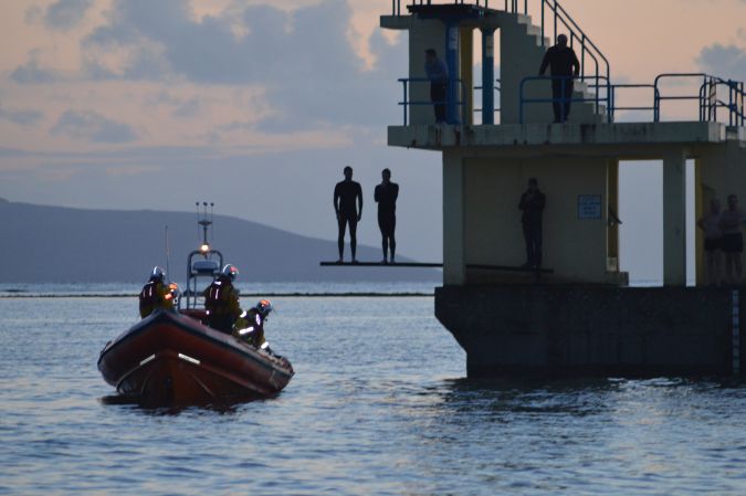 The RNLI Inshore Lifeboat and onlookers keep an eye out for the dolphin in the wake of Wednesday night's incident. Photo: John McGrath, Galway RNLI.