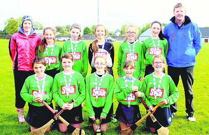 New Inn N.S. winners of the Cumann Na mBunscol Mini Camogie Sevens in Kilconieron. G.A.A. Grounds Back row, left to right: Carmel Hannon (coach), Ciara Griffin, D. Ward, Aisling Dillon, Caoimhe Donohue, Aoibhe Deeley, Diarmuid Burns (Principal). Front row: Reitseal Kelly, Melissa McDonnell, Cora Kenny (captain), Laura Kenny, Emma McKeogh.