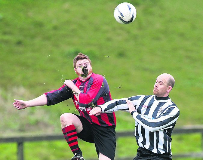 Corofin United's Brian Hession looks like he got a mouthful of grass in this duel with Kevin Fitzpatrick of Galway Hibs in Bohermore on Sunday. Photo: Joe O'Shaughnessy.