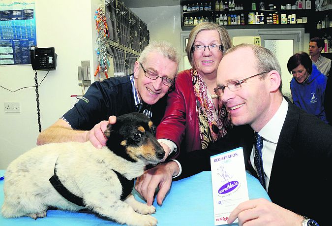 Simon Coveney, Minister for Agriculture, with Spike the dog, and Vet Joe O'Donnell and Helen Cooke, during a visit to Glenina Veterinary Clinic at Glenina on Friday. Minister Coveney announced a national scheme for the microchipping of all dogs, starting this September. Photo: Stan Shields.