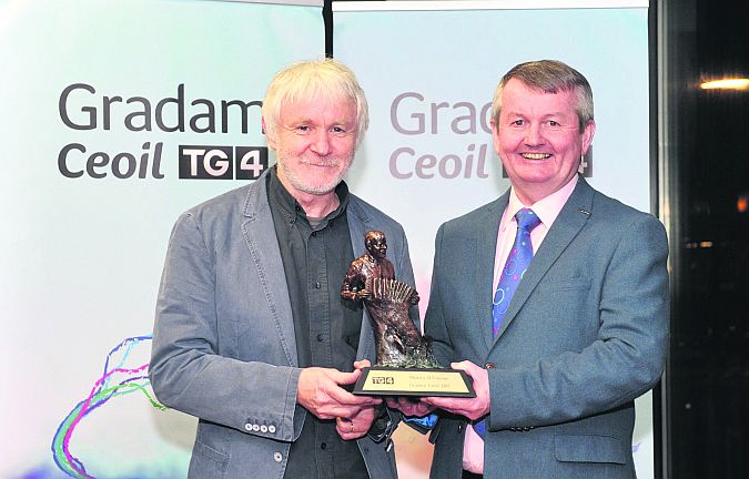 Máirtín O’Connor accepting the overall Gradam Ceoil TG4 award from Pól Ó Gallchóir at a ceremony in the Cork Opera House last weekend; the Award recognises the outstanding achievements of musicians across six various strands of Irish Traditional music.