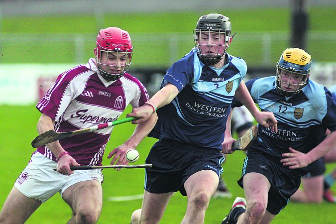 Presentation College's Cillian McDaid looks to break through the challenge of Sean O'Brien of St Brigid's.