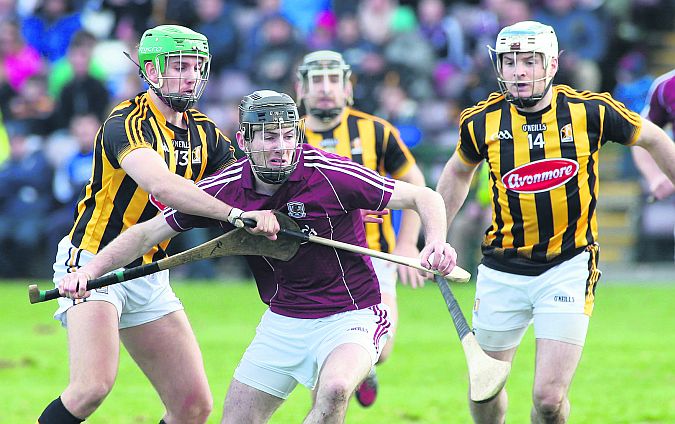 Galway's Padraig Mannion looks to clear his lines under pressure from Kilkenny's Mark Kelly and Jonjo Farrell. Photo: Joe O'Shaughnessy.