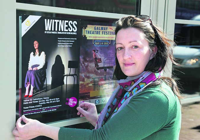 Andrea Kelly putting up posters for her Theatre Festival show, Witness.