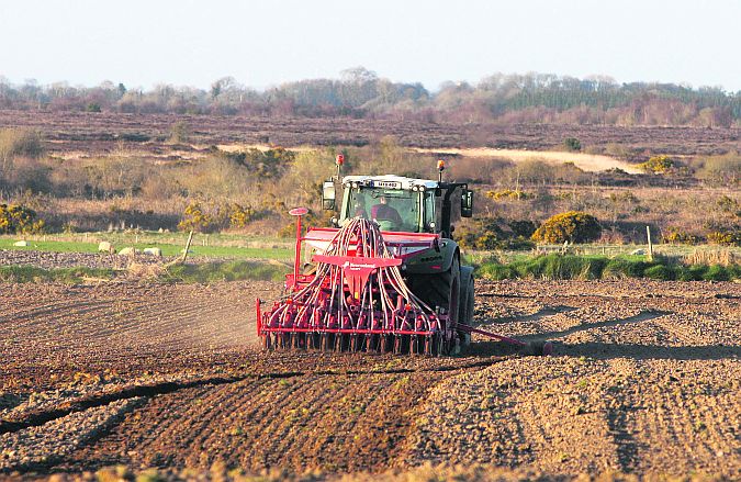 John Daly, Kilconnell, sowing spring barley against the backdrop of Killure Bog. PHOTO: HANY MARZOUK.