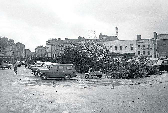 Eyre Square on September 16, 1961 was quite a different place than that of today - and it's not just a question of building changes and road usage. The city was just recovering from one of the most devastating storms of modern times, Hurricane Debbie, and the evidence of the destruction is seen in the felled trees. One of the more notable changes of use is the former Woolworths store, now occupied by Supermac's.