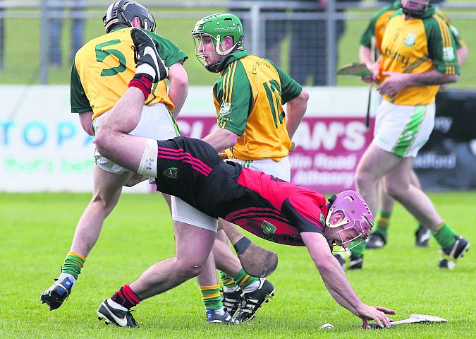 Gerard Kelly of Tommy Larkins in a tussle for possession with Craughwell's Mark Horan and Fergal Healy. Photos: Joe O'Shaughnessy.