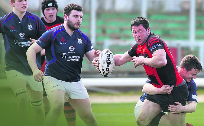 Monivea's Kevin Higgins has his progress hallted during Sunday's Connacht Junior Cup Final at the Sportsground. Photos: Joe O'Shaughnessy.