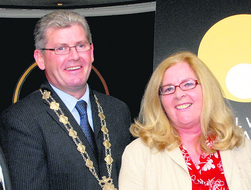 All smiles as Nuala Nolan hands over her dress to Frank Fahy.