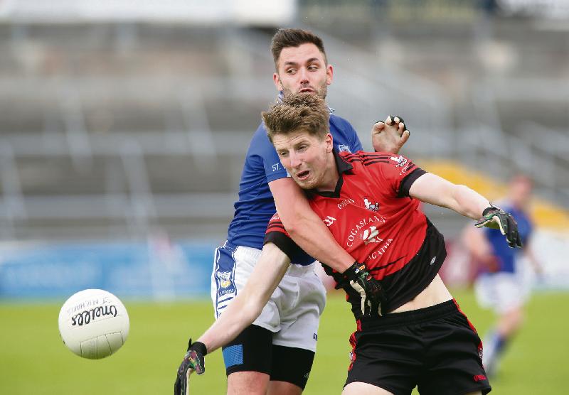 An Cheathrú Rua's Liam Mac Donnacha comes under pressure from St. Michael's Peter Ruane during the clubs' championship clash at Pearse Stadium on Sunday.