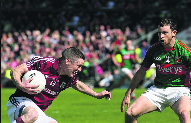 Galway's Danny Cummins secures possession ahead of Mayo's Keith Higgins during the Connacht senior football semi-final at Pearse Stadium on Sunday. Photo: Enda Noone.