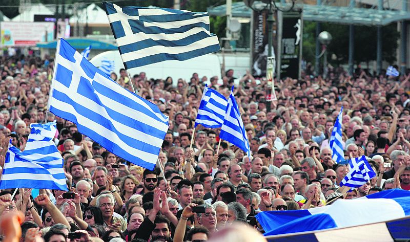 Protesters wave Greek flags during a massive rally against austerity.