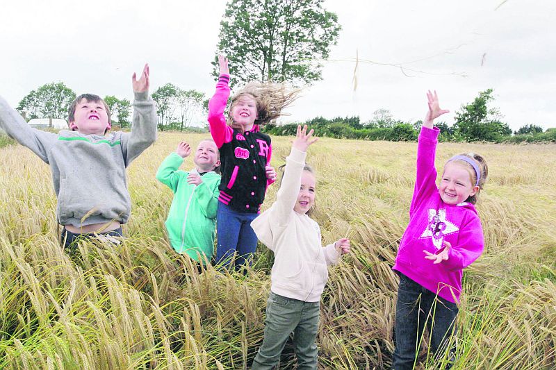 Having fun in a field of barley at the launch of the Mountbellew Annual Vintage Rallythat takes place on this Sunday, July 26 were friends Oisín Crehan and Rebecca Regan with Megan, Caitlin and Michaela Flynn.