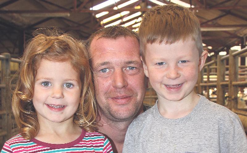 Enda Slevin, Borrisokane, with his children Amy and Jack, at this week’s mart in Portumna. PHOTO: GERRY STRONGE.