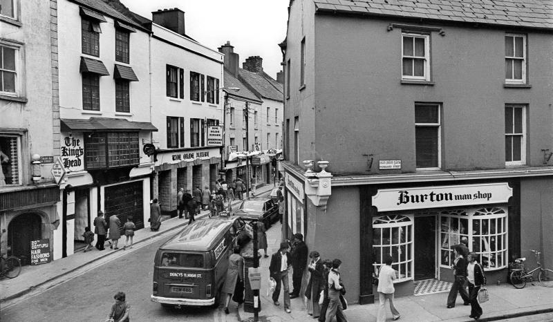 The streetscape has not greatly changed, though some of the commercial enterprises have, since the older photo was taken at the meeting of Mainguard Street and High Street back inJuly, 1977. The biggest difference, though is the presence of vehicles on the now pedestrianised street.