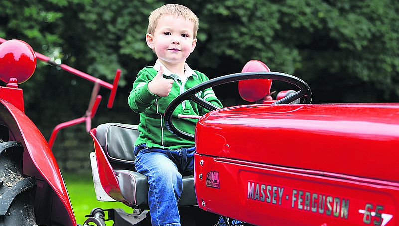 The old Massey-Ferguson 65 gets the approval of two year old Lucas McKenna at the Monivea Fair. PHOTO: HANY MARZOUK.