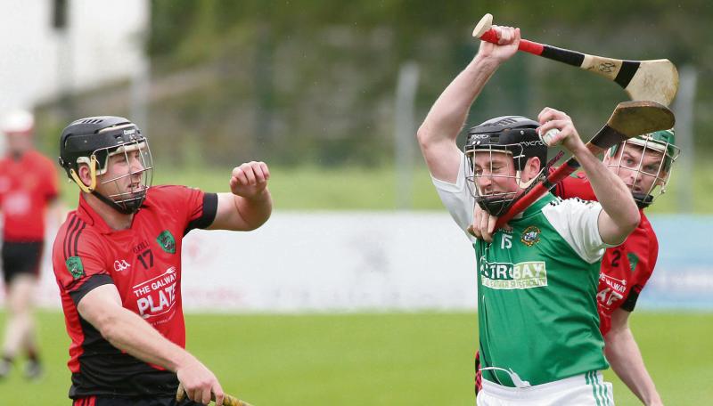 Conor Hynes of Liam Mellows has his progress unceremonously halted by Cappataggle's Shane O'Grady as Cathal Tuohy looks on. Photos: JOe O'Shaughnessy.