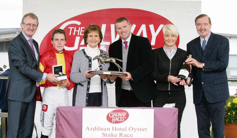 Breda Ryan presents the winning trophy to Mark Weld after Zhukova won the Ardilaun Hotel Oyster Stakes at Ballybrit on Monday. Also included, from left, John Ryan, General Manager, Ardilaun Hotel, Leigh Roche, winning jockey, Maggie Ryan and Dermot Weld, winning trainer.