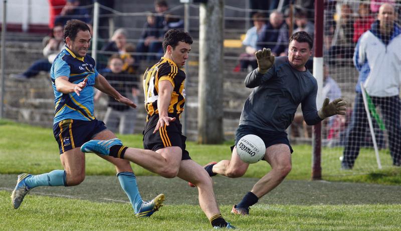 Mountbellew-Moylough's Eoin Finnerty fires past Salthill/Knocknacarra goalkeeper Greg Rogers as Ruaidhri McTiernen closes-in. Photos: Enda Noone.