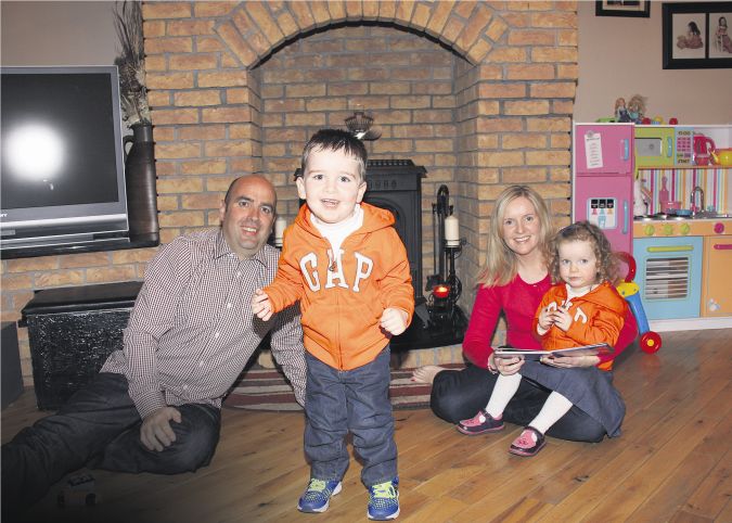 Mark Dolan from Ahascragh walks unaided for the first time in his three year old life. He is pictured with his parents Kevin and Fidelma and twin sister Maeve. Photo: Gerry Stronge.