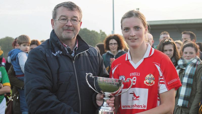Kilkerrin/Clonberne captain Annette Clarke is presented with the senior cup by Ladies County Board Chairman Con Moynihan.