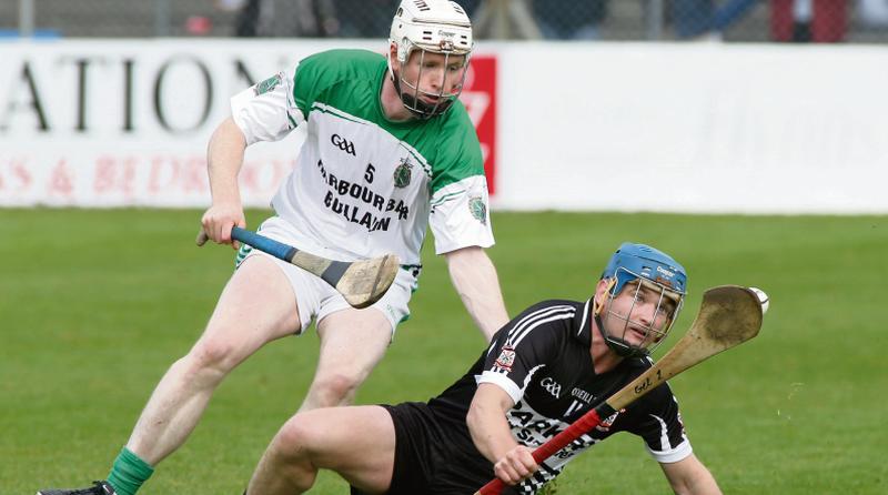 Padraig Pearses Jimmy Gelston comes under pressure from Sarsfields Niall Quinn during Sunday's senior hurling championship quarter-final at Kenny Park. Photos: Joe O'Shaughnessy.