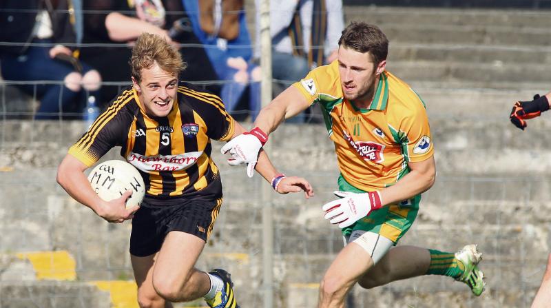 Mountbellew Moylough’s Colm Mannion fends off the challenge of Corofin's Michael Lundy during Sunday’s Galway Senior Football final at Tuam Stadium. Photos: Joe O'Shaughnessy.