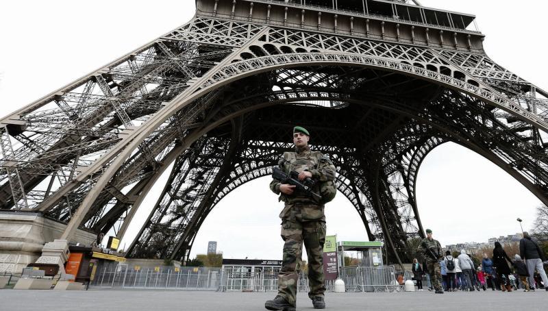 The new reality...armed soldiers at the foot of the Eiffel Tower.