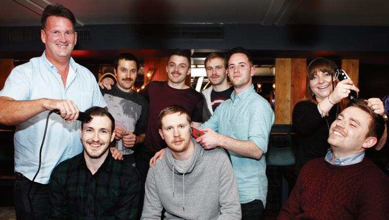 Participants in the FanTASHtic shave off at Seven Bar, Bridge Street (front – from left) James McHale, Kevin McNamara, Dominic Wilkinson, with (back) Dave Gallagher of the Edge barbers, Marius Gordon, Alvin Mitchell, Paul Shaughnessy, and Roy Moore and Sabrina Kinsella of the Edge Barbers.