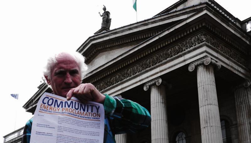 Environmentalist and broadcaster Duncan Stewart pictured outside the GPO, Dublin displaying a copy of the Community Energy Proclamation.