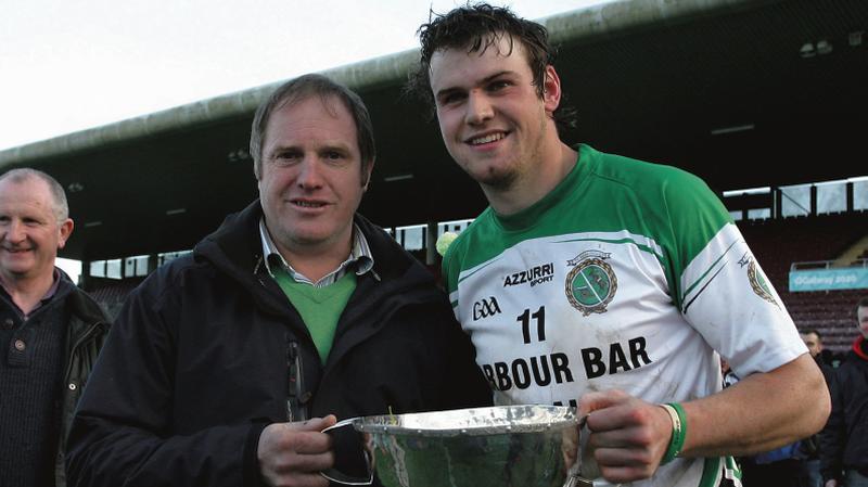 Joseph Cooney, captain of the victorious Sarsfields team, celebates with his father, Galway legend Joe, after the County Hurling Final replay at Pearse Stadium last Sunday week. Joseph will be hoping to achieve a regular role under next year's new Galway manager.