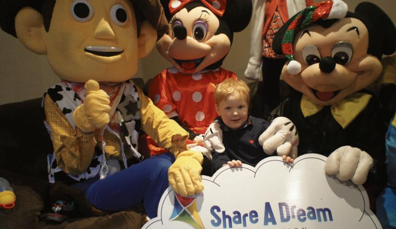 Ronan with his favourite characters Minnie, Mickey and Woody.