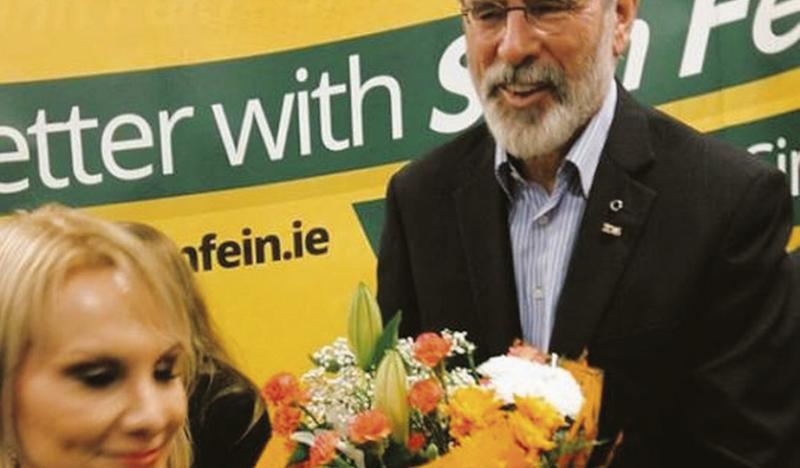 Flowers for her petal: Stephanie Helga presents a bouquet to Gerry Adams in An Cheathrú Rua last week.