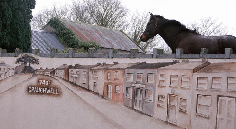 HORSE AND ART .... Orlagh Fahy’s delightful mural on a wall in Craughwell gets the attention of a discerning equine admirer last weekend. The work depicts the town as it would have looked in the 1940s and was painted as part of a village Tidy Towns project. PHOTO: HANY MARZOUK.